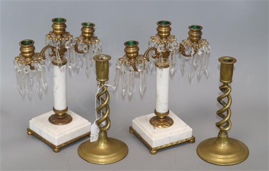 A pair of three branch brass and marble lustre drop candlesticks and a pair of brass twist stem candlesticks